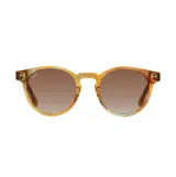 Lentes de sol Indie modelo Pacific Whiskey, con armazón redondo de acetato en tonos ámbar y marrón con detalles translúcidos. Cuenta con cristales marrones degradé polarizados.