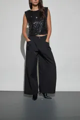Pantalon negro de corte holgado y estilo cargo, con cintura elástica, bolsillos laterales y terminación ajustada en los tobillos.