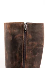 Bota de cuero color marrón con efecto desgastado, caña alta y suela track.