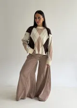 Sweater de punto con diseño de rombos en tonos marrón, beige y celeste, de corte holgado, cuello redondo y manga larga.