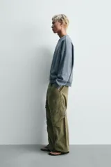 Sudadera de corte relaxed fit confeccionada en tejido de algodón con interior de rizo. Presenta cuello redondo, manga larga y acabados en rib, con un acabado de efecto lavado que le otorga una apariencia única.