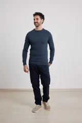 Sweater de punto liso, color azul, con escote redondo y manga larga.