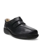 Zapato casual de cuero negro con cierre de doble tira de velcro, diseñado para brindar comodidad y soporte, con suela ergonómica y costuras reforzadas.