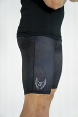 Calza deportiva negra con estampado abstracto en tonos grises, con logo de la marca en la pierna izquierda.