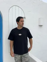 Remera negra de corte boxy con parche bordado en el pecho.