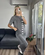 Conjunto negro con pequeños lunares dorados, compuesto por una remera de mangas cortas y un pantalón palazzo con cintura elastizada.