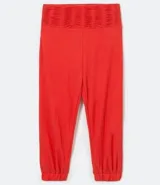 Pantalón jogger color naranja, con cintura alta elástica y terminación ajustada con elástico en los tobillos.