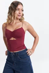 Top negro de tirantes finos con diseño de escote fruncido y abertura cut-out triangular en el centro del pecho. Confeccionado en tejido elástico, presenta un corte ajustado al cuerpo.