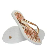 Sandalias tipo ojotas Havaianas modelo Slim Organic, con base negra y estampado floral en tonos rosados y dorados. Presentan tiras finas de color negro con textura grabada.