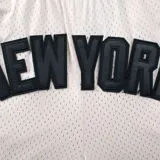 Short deportivo negro de poliéster con cintura elástica ajustable con cordón. Estampado con el nombre "New York" en letras grandes y el logo de los Yankees en la pierna derecha.