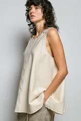 Musculosa de felpa francesa con efecto acid wash, corte en línea A y tirantes ajustables con hebilla en los hombros. Presenta costuras verticales decorativas y bajo acampanado.