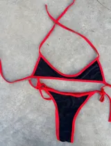 Conjunto de bikini con corpiño triangular y bombacha cavada con tiras finas.