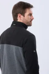 Buzo de polar bicolor azul marino y verde con medio cierre y bolsillos laterales con cierre.