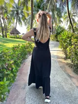 Vestido largo fucsia con breteles finos y detalle de tachas doradas en los breteles.