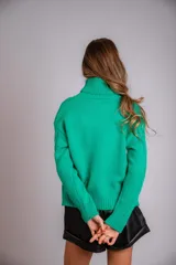 Suéter tejido de punto trenzado color salmón, con cuello alto y mangas largas. Corte ajustado al cuerpo.