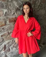 Vestido corto rojo con cuello camisero, botones frontales, mangas largas acampanadas y corte evasé.