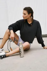 Buzo de algodón negro, de manga larga con efecto globo y puños ajustados. Presenta escote redondo y calce ligeramente cropped y holgado.