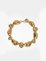 Collar de piezas metálicas con diseño de formas orgánicas en color dorado y cierre de mosquetón.