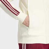 Campera deportiva Adidas Originals de la selección de España, color blanco con detalles en bordó. Presenta cuello tipo polo, cierre frontal con cremallera, las icónicas tres tiras en las mangas y el escudo de la selección junto al logo del trébol en el pecho.