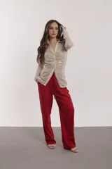 Camisa color beige con lentejuelas, de corte ajustado, cuello camisero y cierre frontal con botones.