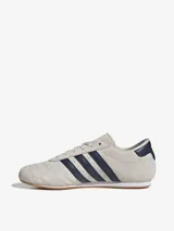 Championes Adidas Taekwondo Lace color crema con detalles en azul marino.