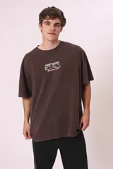 Camiseta de manga corta, color gris oscuro con efecto lavado, corte oversize y cuello redondo. Presenta un pequeño estampado en el pecho con el texto "CREW MEMBER" en blanco.