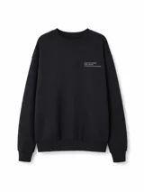 Buzo de cuello redondo en color negro, con diseño de calce holgado y puños elásticos. Presenta una pequeña estampa tipográfica en el pecho.