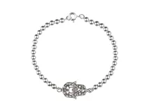 Pulsera de plata 925 con dije de mano de Fátima calada.