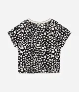 Blusa de crepé con estampa de manchas en blanco y negro, mangas cortas y escote en pico con borde contrastante.
