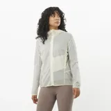 Campera cortavientos de mujer Salomon Sense Aero Wind, ultraligera y transpirable, color blanco semitransparente, con capucha y cierre frontal completo.