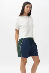 Short deportivo negro con detalles en verde militar, cintura elastizada, bolsillos laterales y ribete blanco.