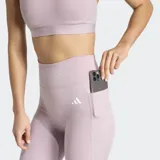 Calza de entrenamiento de tiro alto Adidas, color lila, con ajuste ceñido y bolsillo oculto en el muslo. Confeccionada con tecnología AEROREADY para mayor absorción de humedad.