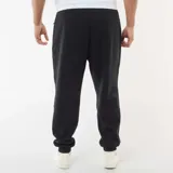 Pantalón de chándal tipo jogger de punto piqué, color negro, con cintura elástica y puños acanalados en los tobillos.