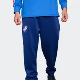 Pantalón de entrenamiento Umbro del Club Nacional de Football, color azul, con escudo del club estampado en la pierna derecha.
