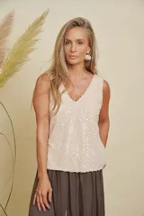 Musculosa color beige con lentejuelas diagonales, escote en V y corte holgado.