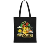 Tote bag de tela color negro con estampado frontal colorido de estilo retro que incluye una caja con rostro, flores, sol y la frase Empathy Will Save The World.