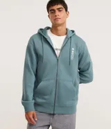 Hoodie canguro verde azulado con cierre frontal de cremallera, capucha ajustable con cordón y bolsillos tipo canguro. Presenta una pequeña estampa gráfica localizada en el pecho.