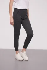 Calza negra de tiro alto con cierre lateral y detalle de costura en la rodilla.