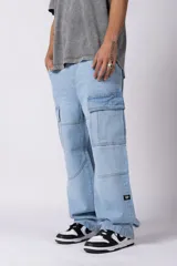 Jean cargo de corte baggy y tiro medio, confeccionado en denim de color celeste con lavado soft. Presenta bolsillos laterales tipo cargo con solapa, costuras reforzadas en las rodillas y un calce holgado con caída relajada.