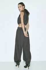Pantalón de popelina de algodón negro, de corte ancho y silueta globo con cordón ajustable en los bajos y en la cintura elástica.