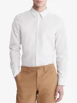 Camisa blanca de vestir, corte slim fit, con cuello clásico, cierre con botones y logo bordado en el pecho.