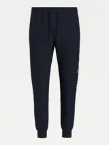 Pantalón de jogging azul marino de algodón orgánico, con corte cónico, cintura elástica con cordón, bolsillos laterales y trasero, y logo de Tommy Hilfiger estampado en la pierna.