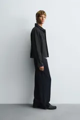 Pantalón relaxed fit color azul marino, confeccionado en tejido fluido con viscosa. Cuenta con cintura elástica ajustable con cordón interior, bolsillos laterales y bolsillos traseros de vivo. Las perneras tienen costura frontal y el bajo es ajustable con cremalleras laterales.