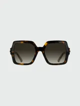 Lentes de sol Longchamp con armazón de acetato en tono marrón traslúcido y diseño cuadrado de gran tamaño. Presentan cristales con degradado y detalles metálicos dorados en las patillas.