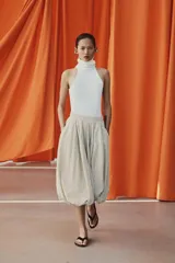 Falda midi de tiro medio color beige con estampado de cuadros finos oscuros. Presenta pliegues en la cintura y bajo abullonado con acabado evasé, de Zara Woman Collection.