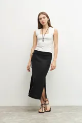 Falda midi negra de lino, con cintura alta y lazo ajustable, y tajos laterales.