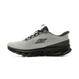 Championes deportivos Skechers Slip-Ins Go Walk Glide Step, color gris con suela negra y detalles en naranja. Diseño sin cordones con parte superior de malla técnica y entresuela geométrica.