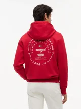 Buzo con capucha de Tommy Hilfiger en colaboración con Cadillac Formula 1 Team. Confeccionado en algodón, presenta un diseño de color rojo con bolsillo tipo canguro, puños y bajo acanalados. Incluye bordados en el pecho con banderas cruzadas y el logo de la colaboración.