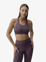 Top deportivo de cuello redondo con espalda estilo nadador, confeccionado en tejido técnico compacto y ligero con estampado de monograma BORN. Cuenta con copas extraíbles y banda elástica inferior para mayor sujeción.