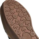 Championes adidas Gazelle Bold de diseño plataforma, confeccionados en gamuza negra con las icónicas tres tiras blancas laterales y detalle de marca en el talón. Presentan una suela de goma apilada en tonos marrones y lengüeta con textura geométrica.